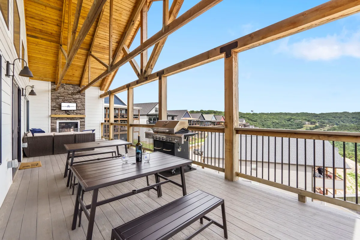 An inviting outdoor dining area complete with a grill, seating, and a panoramic scenic view. The space is set up for barbecues, socializing, and enjoying sunsets—an ideal setting for sharing stories and meals after a fun-filled day at nearby attractions.